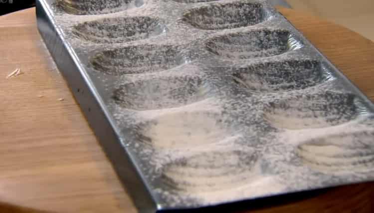 To make Madeleine cookies, sprinkle flour with a mold