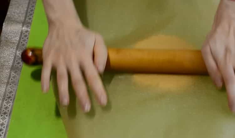 Roll out the dough to make cookies in a pan