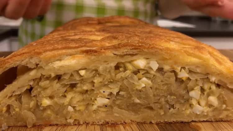 The delicious pie with cabbage and egg in the oven is ready