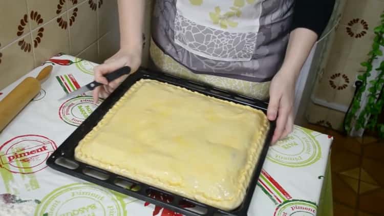 To make a pie with fish and potatoes, grease the dough with an egg