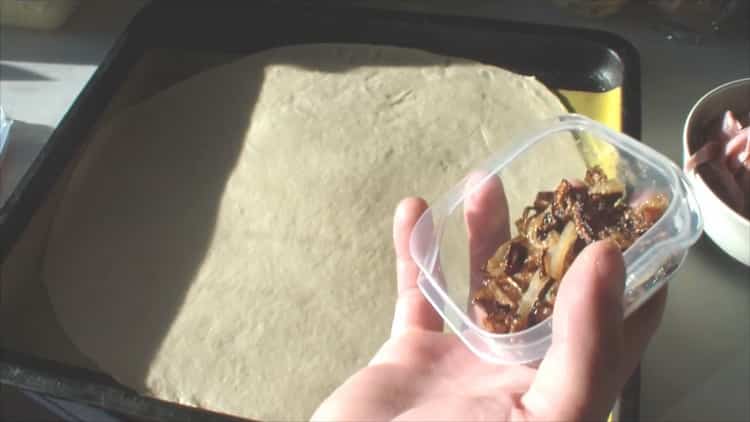 Roll out the dough to make assorted pizza