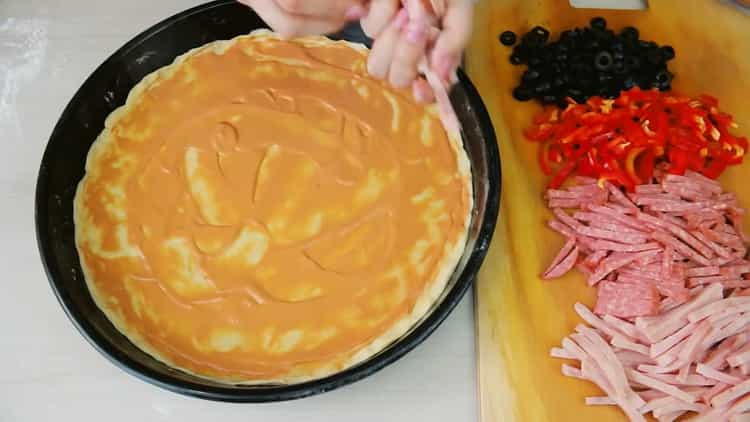 To make pizza without yeast, grease the dough with sauce