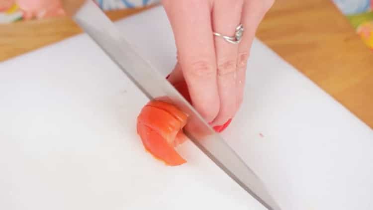 To cook pizza in the microwave, chop the tomatoes