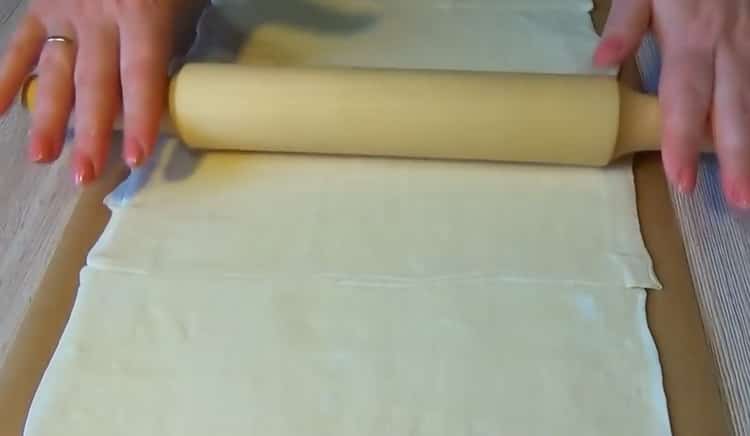 To make puff pastry pizza, roll out the dough