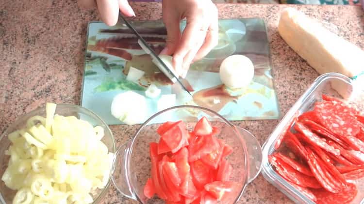 To make puff pastry pizza in the oven, chop onions