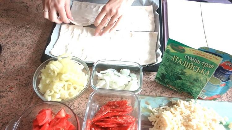 To prepare pizza from puff pastry in the oven, place the dough on a baking sheet