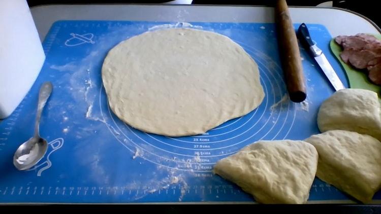 To make pizza on kefir in the oven, roll out the dough