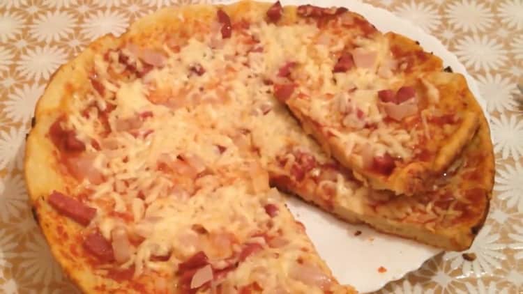 pizza on sour cream and mayonnaise in a pan is ready