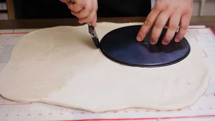 To make a pizza pie, roll out the dough