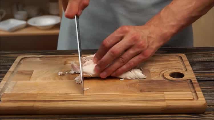 To make pizza with chicken and pineapple, chop the meat