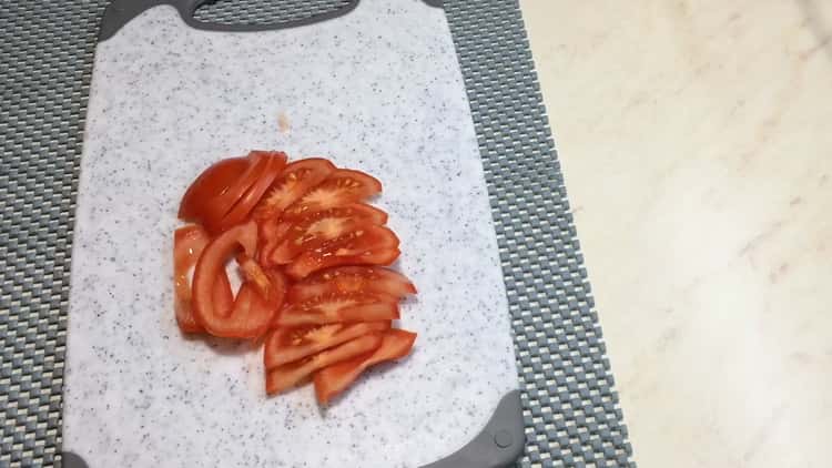 To make Caesar pizza, chop the tomatoes