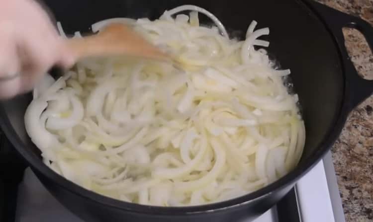 To cook lamb pilaf in a cauldron, fry the onion