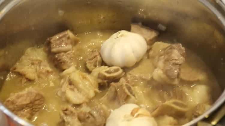 To make pork pilaf in a saucepan add garlic