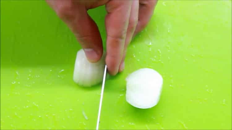 To cook fish in a creamy sauce, chop the onion