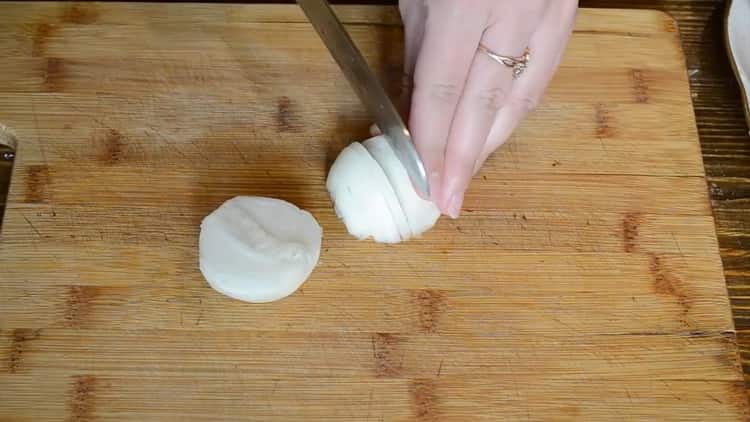 To cook fish on sour cream in the oven, chop the onion
