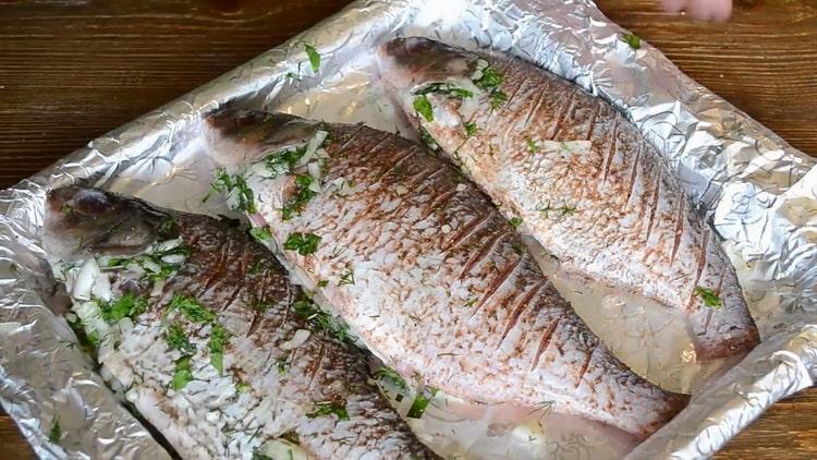 To cook fish on sour cream in the oven, put the ingredients in a baking sheet