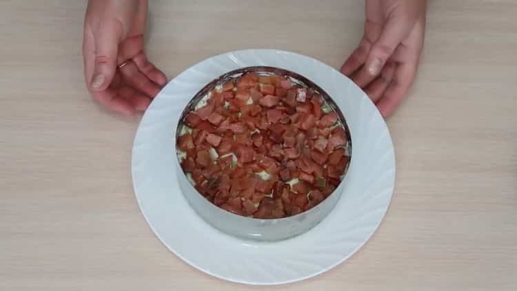 To prepare a salad with avocado and salmon, lay out all layers