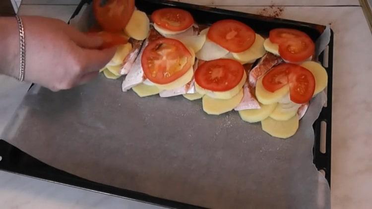 To cook salmon with potatoes in the oven, chop the tomatoes