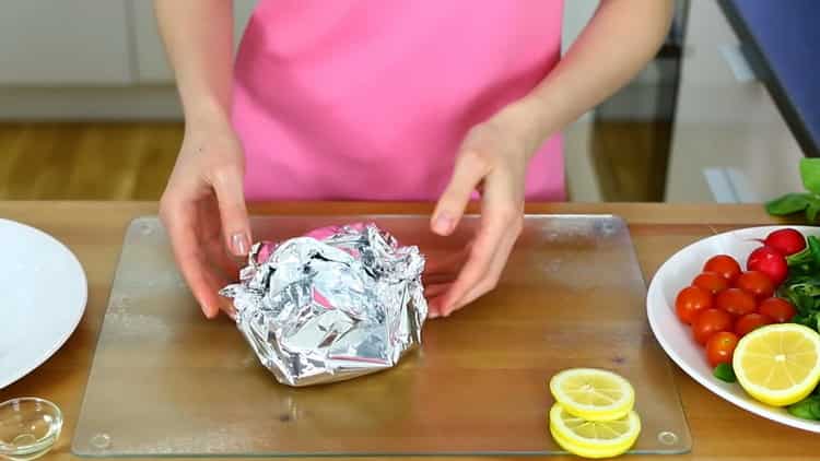 To cook a salmon skate in the oven, roll the meat in foil
