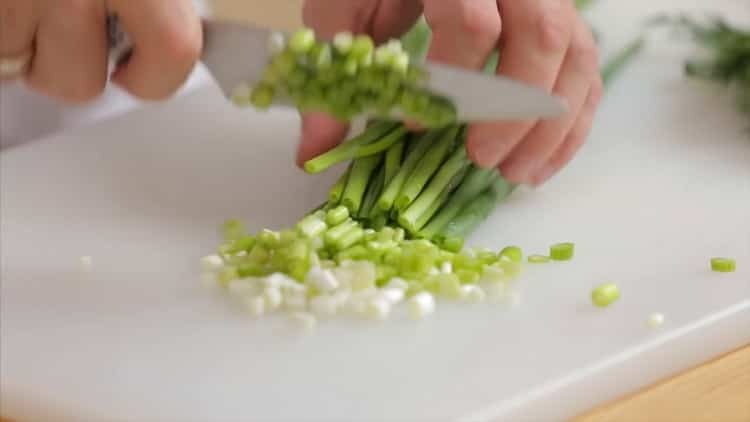 To make pink salmon soup, chop the greens