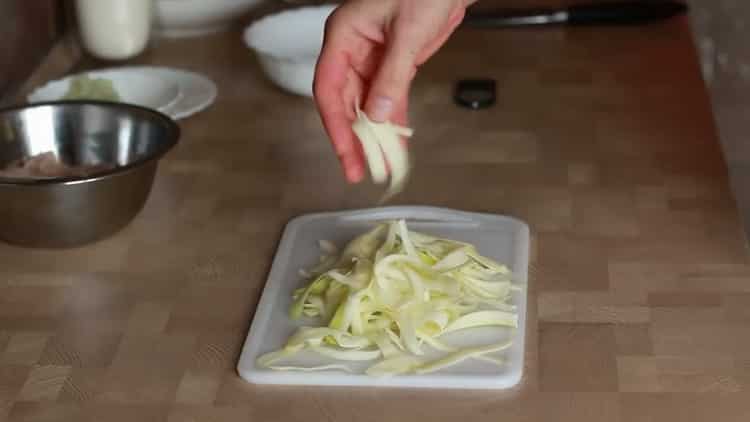 Chop zucchini to make chicken fettuccine