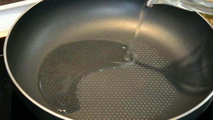 According to the recipe for cooking pollock fillet in a pan, heat the pan