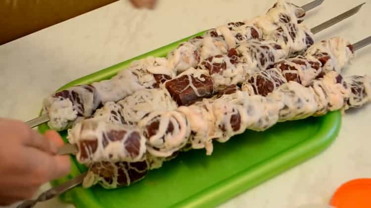 To cook beef skewers, put meat on a skewer