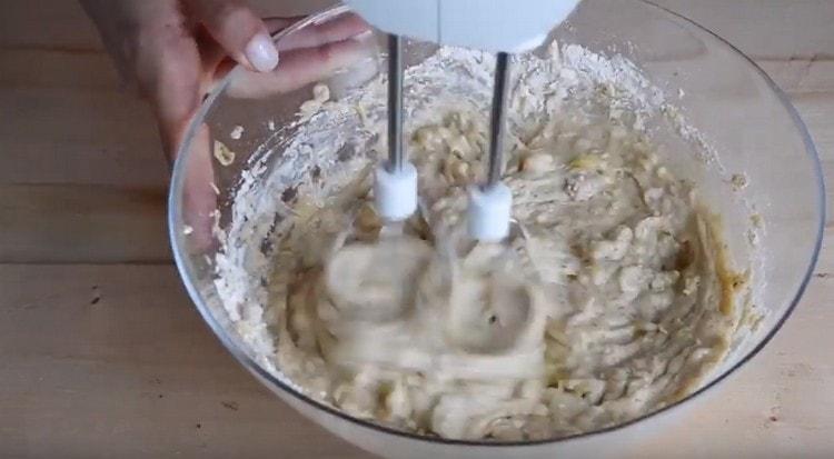 Mix dry and liquid components with a mixer.