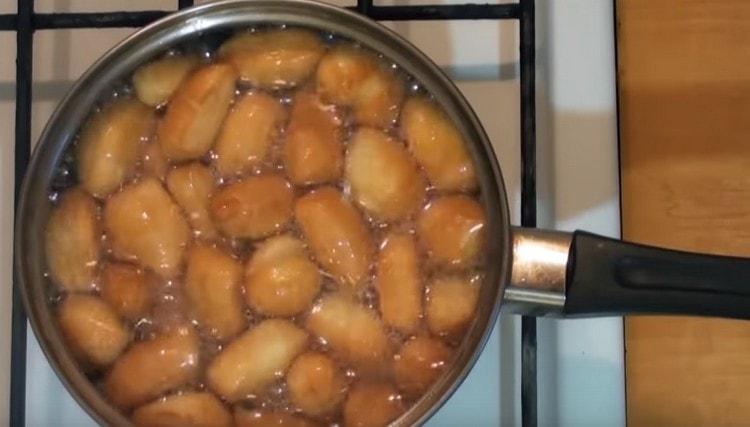 Fry the baursaki until golden brown.