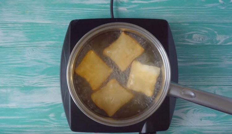 We spread the baursaki to fry in hot vegetable oil.