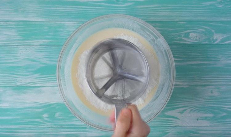 Sift flour into kefir mass.