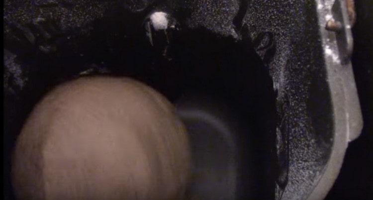 Set the bucket of ingredients in the bread machine and wait for the dough to knead.