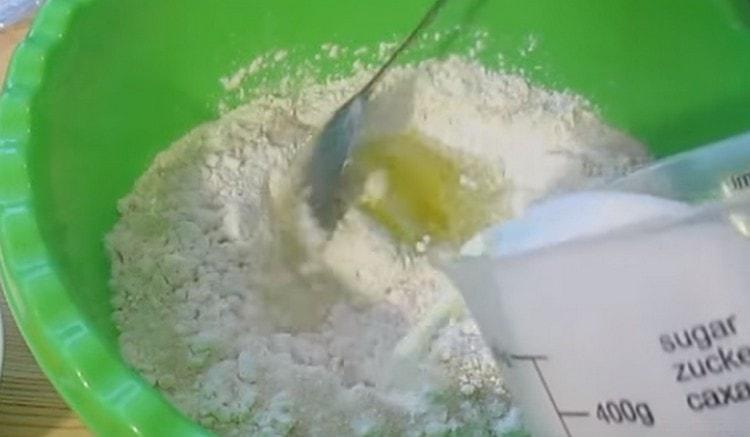 Add slightly warmed milk and knead the dough.