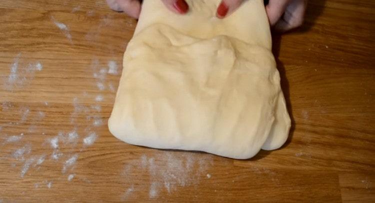 We knead the dough, roll it out a little and fold it with an envelope.