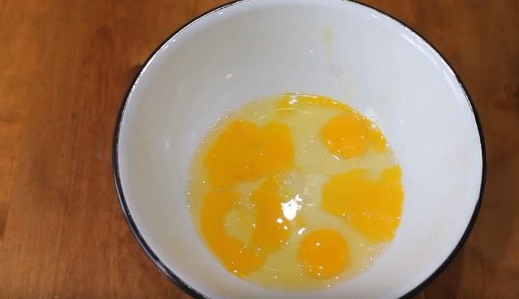 Eggs are beaten into a bowl.