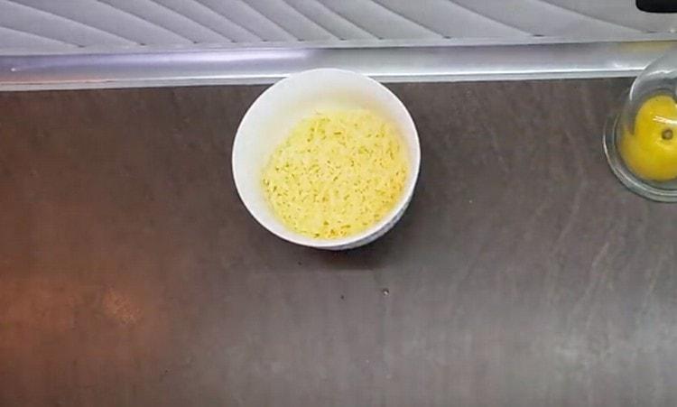 While the fish is baking, grate the cheese.