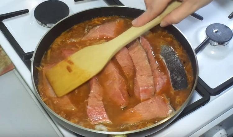 When the gravy boils, put the pieces of fish in it.