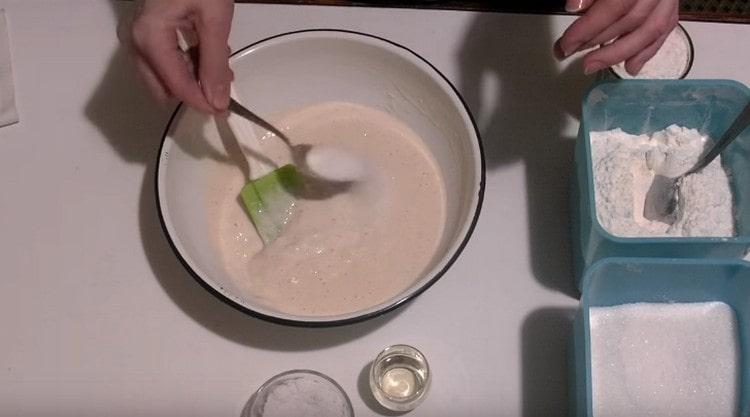 Add salt and sugar to the risen dough.