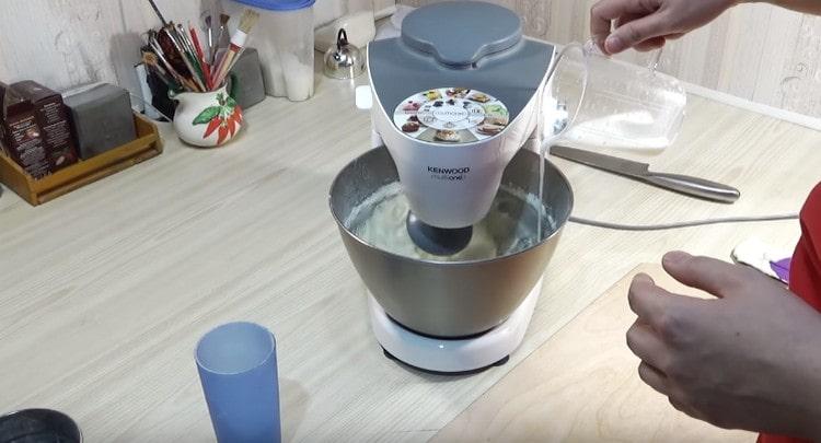 When whipping in a thin stream, we introduce warm milk into the dough.