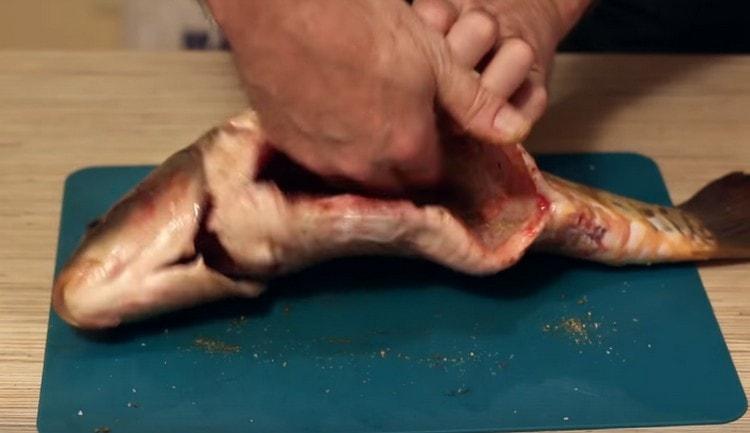 Rub the fish with a mixture of salt and spices.