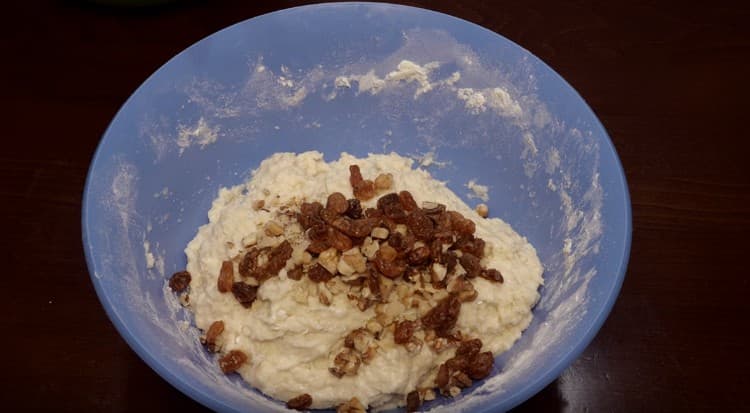 We got a thick sticky dough, mix nuts with raisins in it.