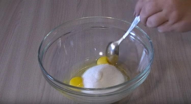 Add sugar to the eggs, mix.