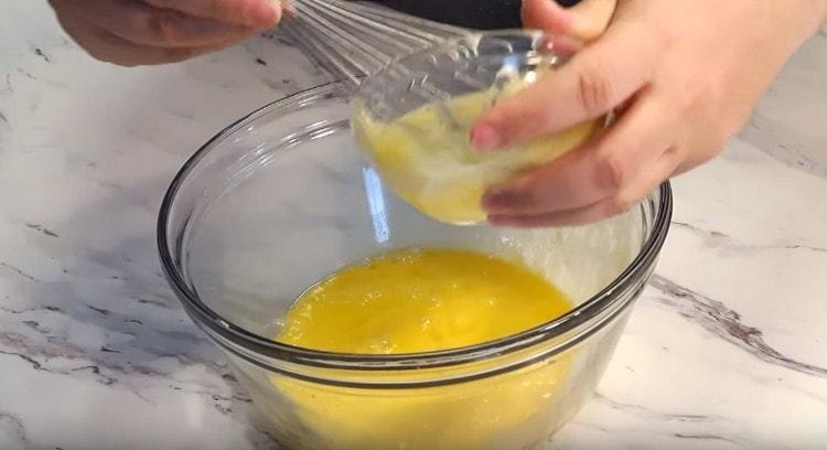 Add softened butter to the egg mass.