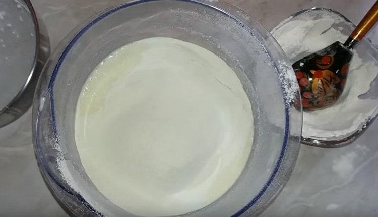 Add the flour to the dough in parts.