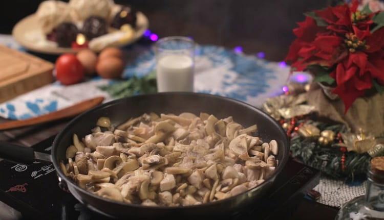 Add mushrooms to the chicken, fry together, salt, pepper.
