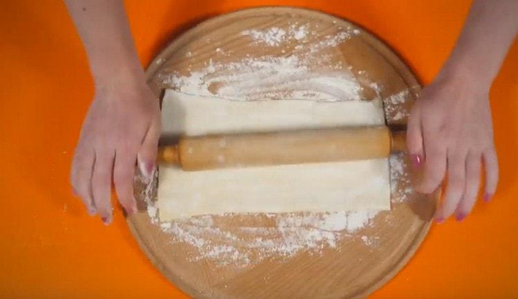Roll the dough lightly with a rolling pin.