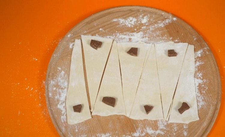Put a piece of chocolate on the wide part of each triangle.