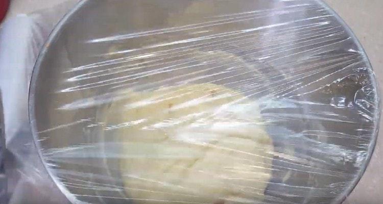 cover the bowl with the dough with cling film and set in a warm place to rise.