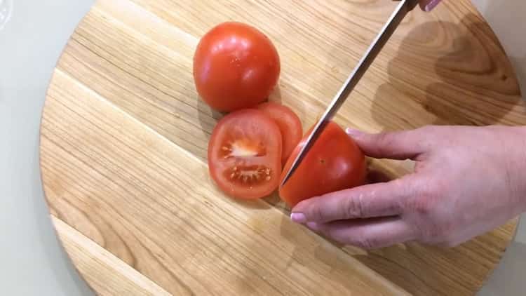 Chop tomatoes for cooking