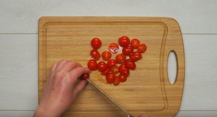 Halve the cherry tomatoes.